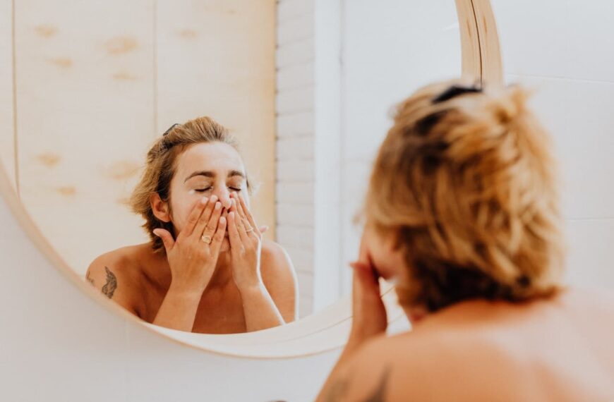 Woman Washing Face With Cream Cleanser